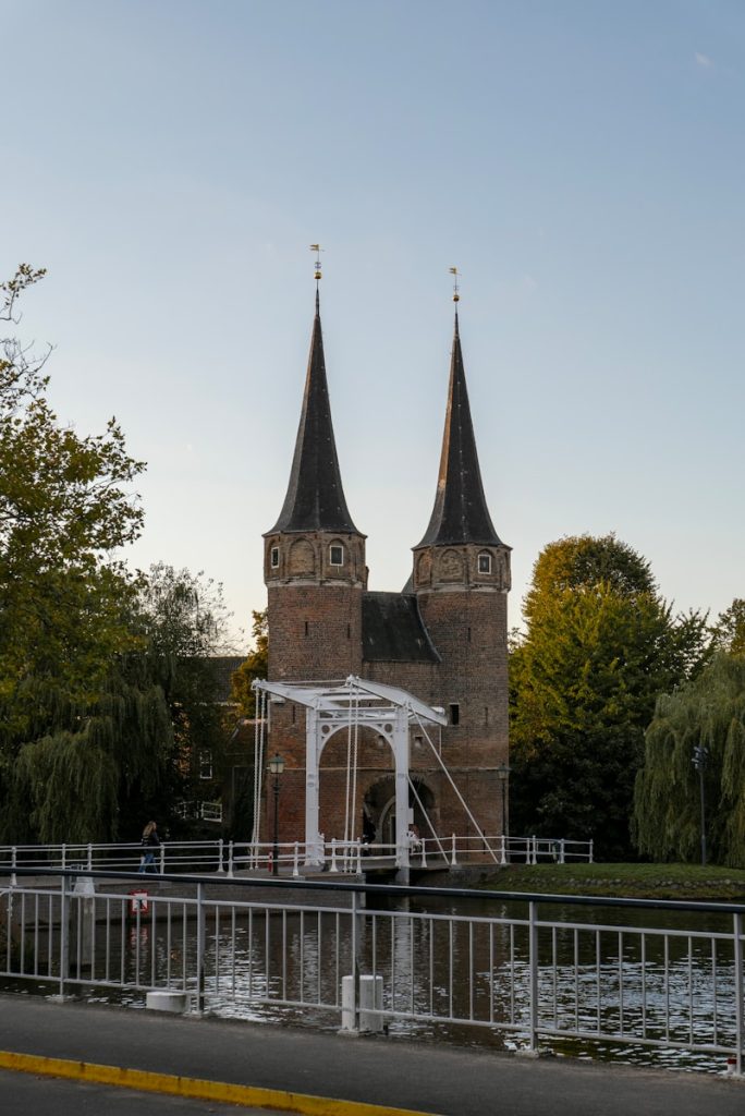 A large building with two towers next to a body of water dagje Zwolle met kinderen Sassenpoort