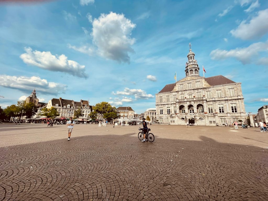 a large building with a dome and a person riding a bike maastricht